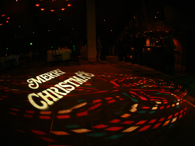 Christmas monogram projected onto the floor at an event