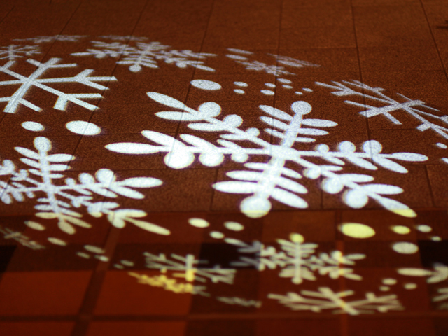 Snowflake monogram projected onto the floor at an event