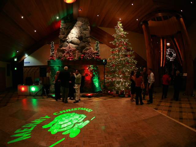 Christmas monogram projected onto the floor at an event 