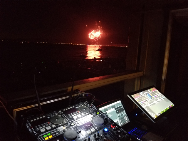 DJ Setup with Fireworks in the Background